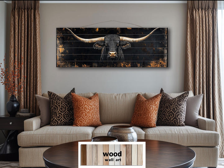 Black Texas Longhorn long horizontal wood wall art hanging above a tan sofa in a living room.