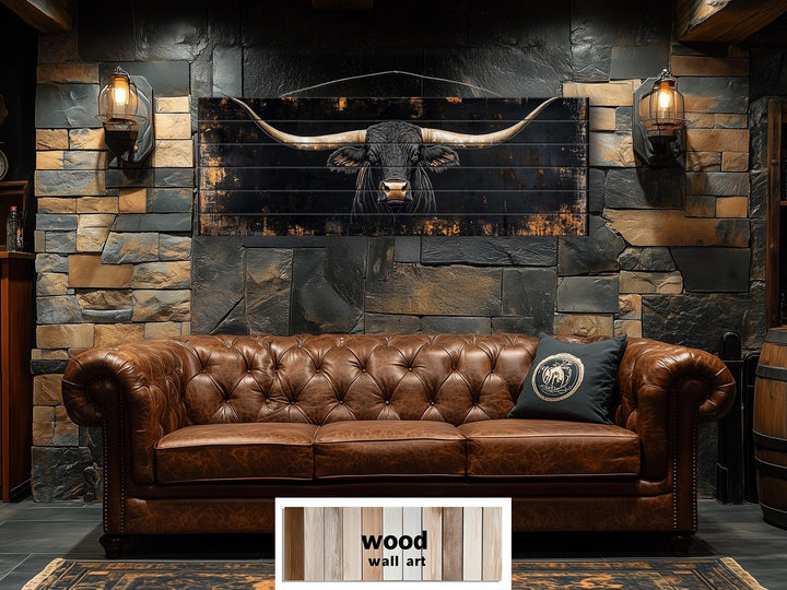 Black Texas Longhorn printed on horizontal wood planks above a brown leather tufted sofa.
