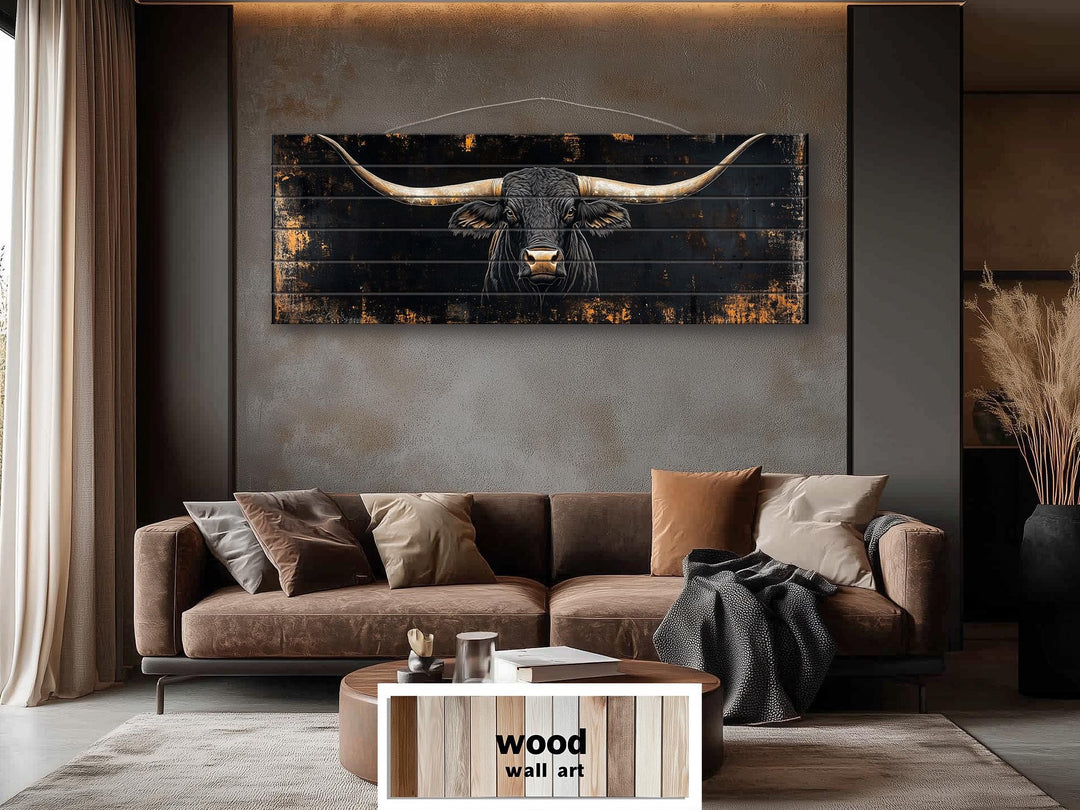 Black Texas Longhorn long narrow real wood wall art hanging above a brown sofa in a living room.