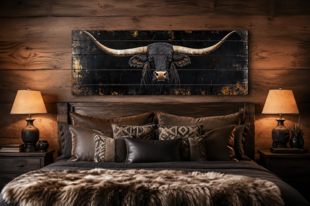 Black Texas Longhorn printed on horizontal wooden planks, hanging above a bed in a rustic bedroom.
