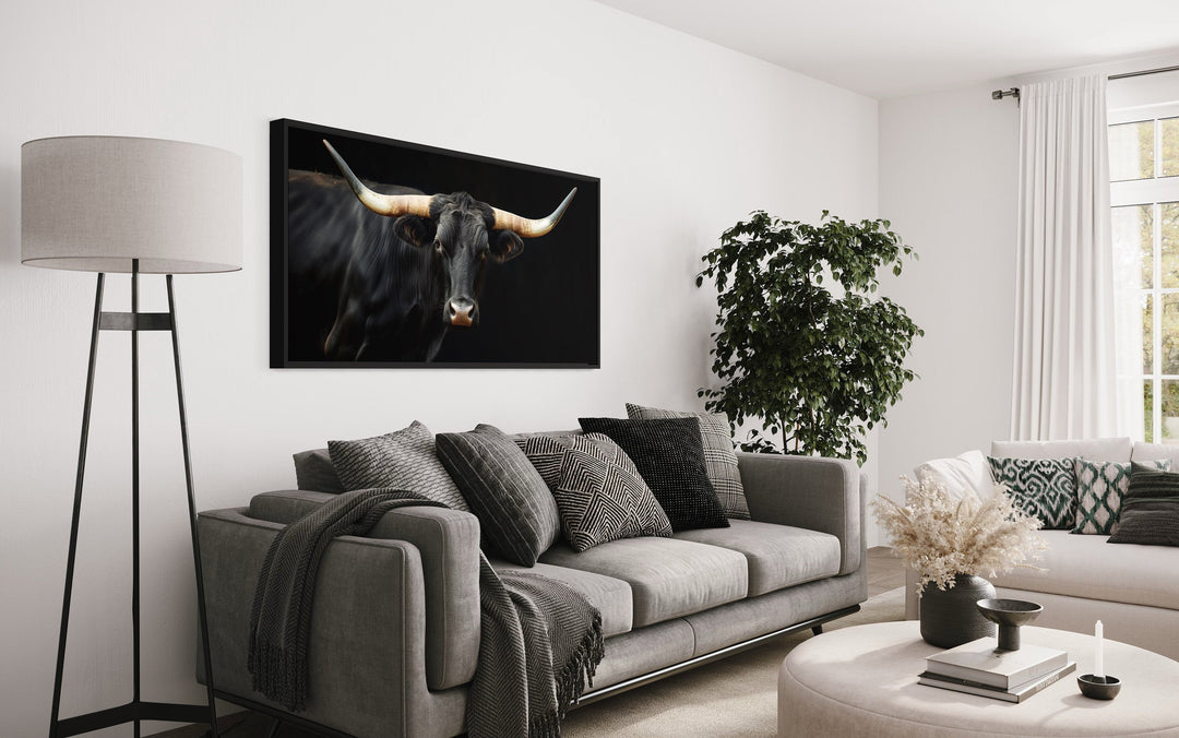 Extra large framed canvas print of a black Texas Longhorn bull in a modern living room setting.