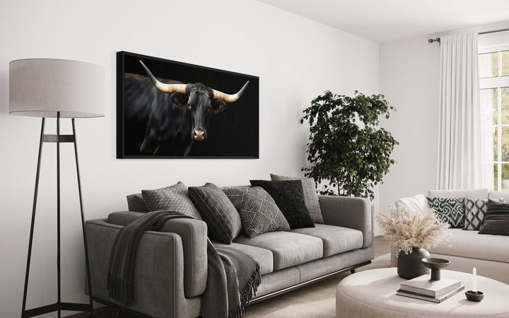 Extra large framed canvas print of a black Texas Longhorn bull in a modern living room setting.