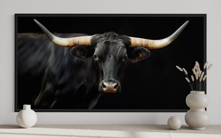 Extra large framed canvas print of a black Texas Longhorn bull against a dark background.