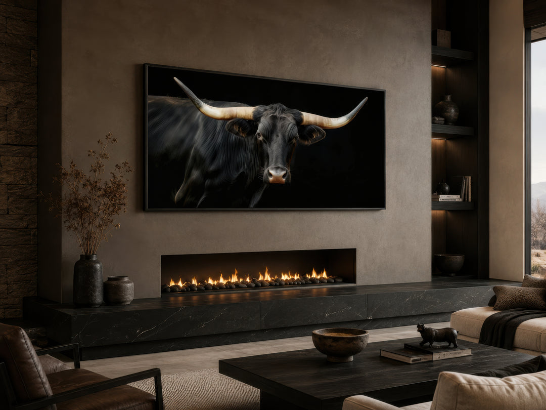 Extra large framed canvas print of a black Texas Longhorn bull above a modern fireplace.