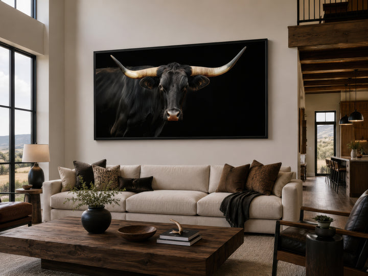 Extra large framed canvas print of a black Texas Longhorn bull in a modern rustic living room.