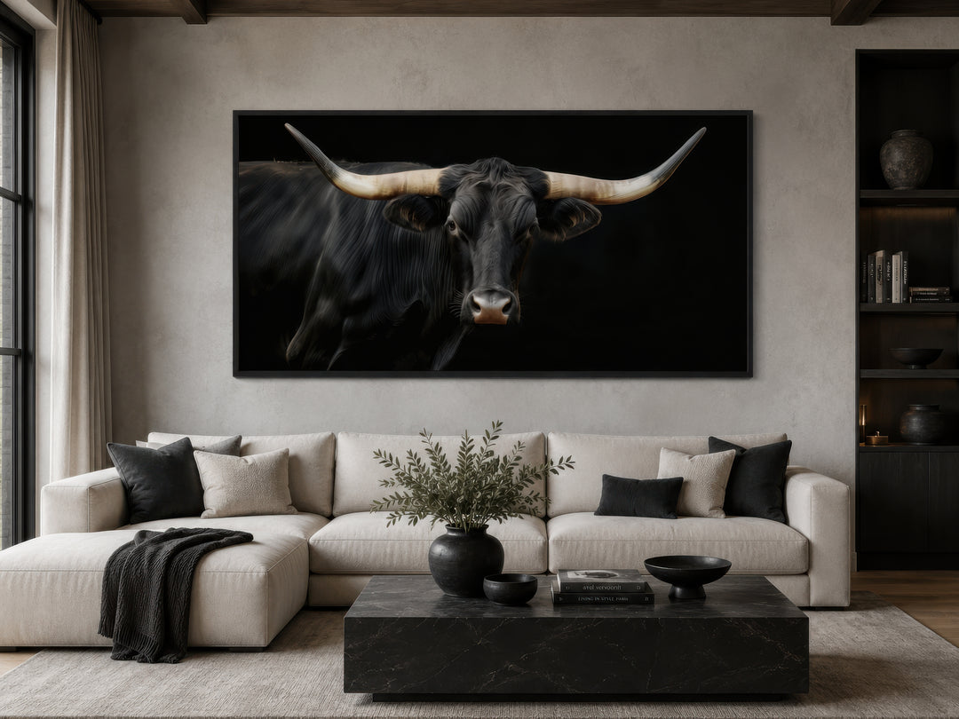 Extra large framed canvas print of a black Texas Longhorn bull above a modern sofa.
