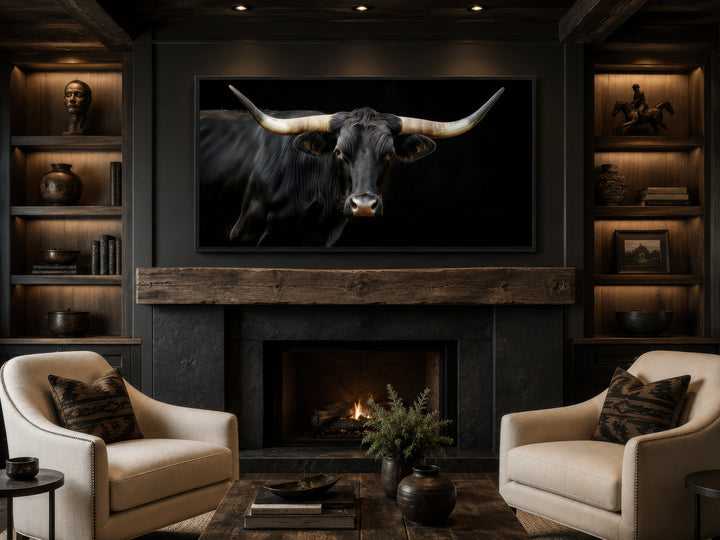 Extra large framed canvas print of a black Texas Longhorn bull above a rustic fireplace.