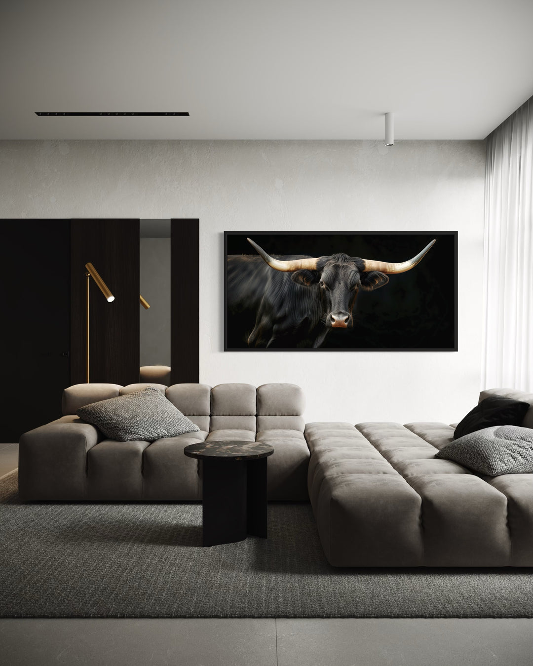 Extra large framed canvas print of a black Texas Longhorn bull above a modern grey sectional sofa.