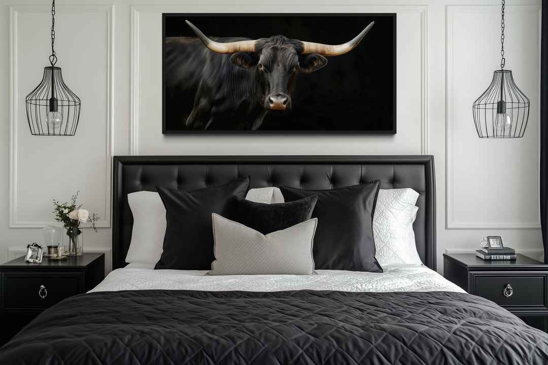 Extra large framed canvas print of a black Texas Longhorn bull above a bed in a modern bedroom.
