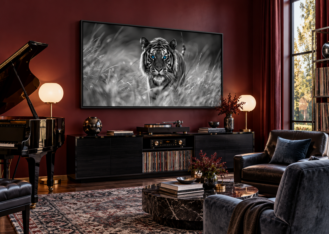 Black and white framed tiger canvas with blue eyes on a burgundy wall in a modern music lounge.