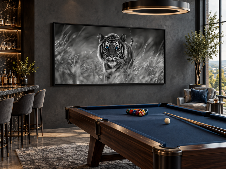 Black and white tiger wall art with blue eyes on a dark wall in a modern billiards lounge.