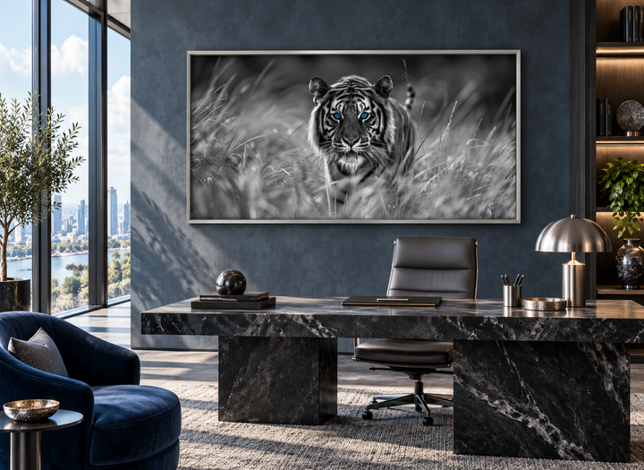 Framed black and white canvas of a tiger with blue eyes hanging in a modern executive office.