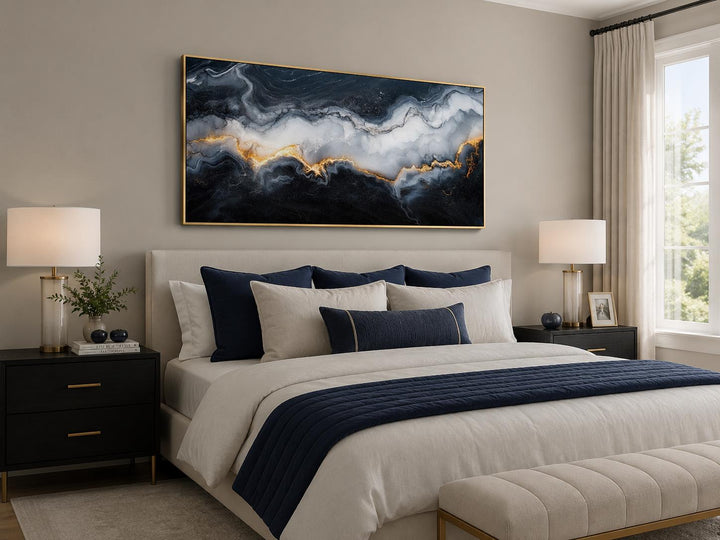 Large horizontal abstract marble canvas print with black, white, and gold veining above a bed.