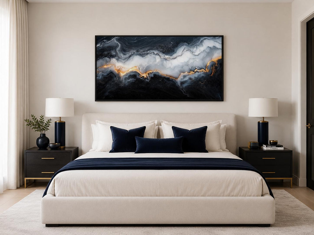 Black, white, and gold abstract marble canvas print hanging above a bed in a modern bedroom.