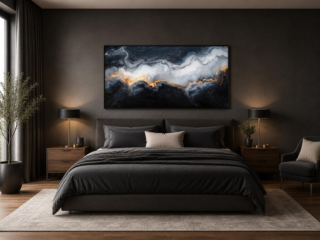 Black, white, and gold abstract marble canvas print hung above a bed in a dark, modern bedroom.