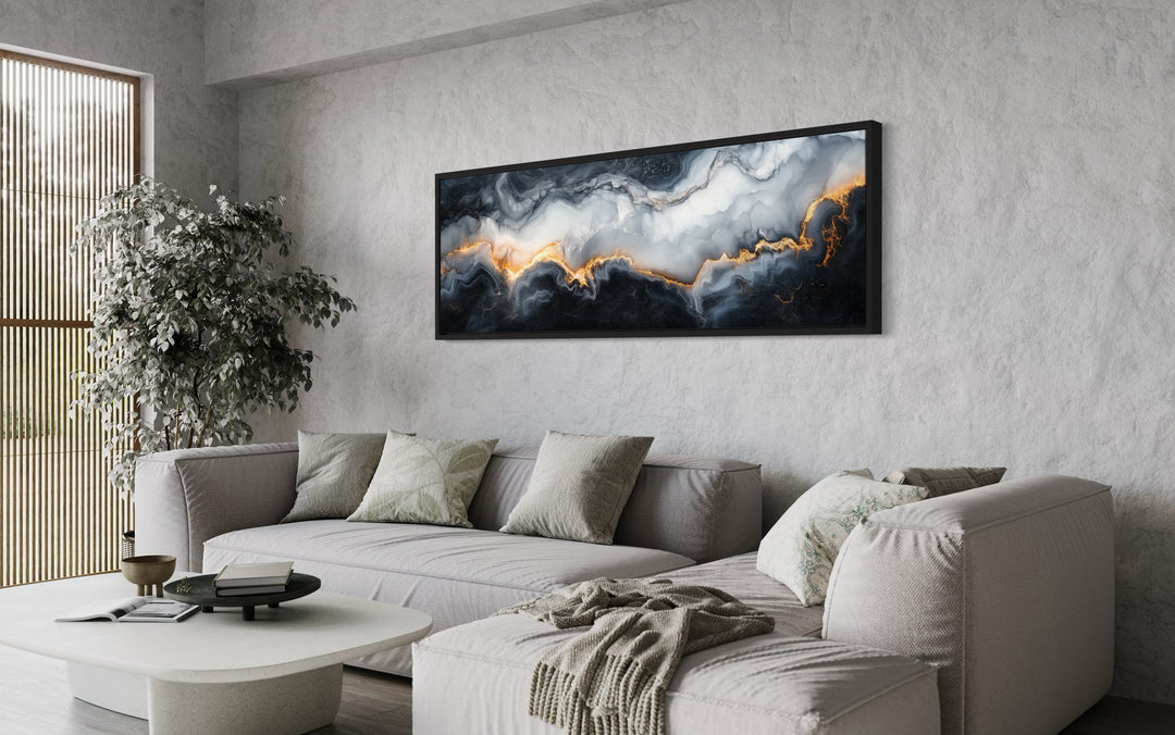 Long horizontal framed canvas wall art with black, white, and gold marble abstract painting.
