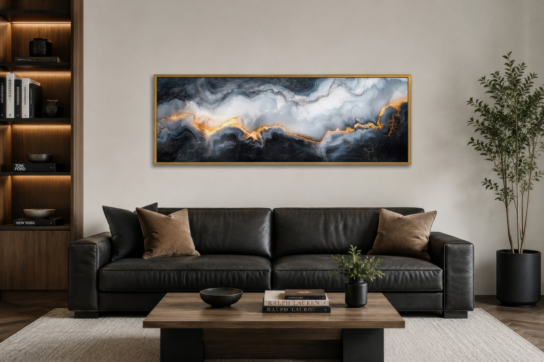 Long horizontal framed canvas wall art featuring a black, white, and gold marble abstract painting.