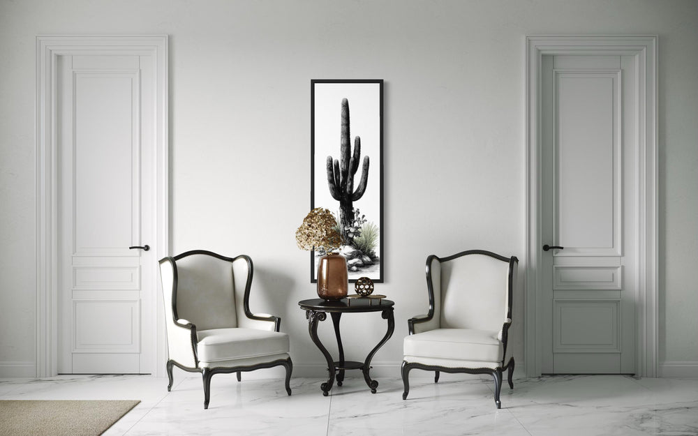 Tall narrow black and white saguaro cactus canvas wall art in a vertical black frame.