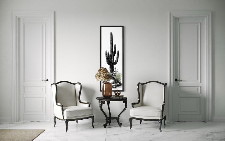 Tall narrow black and white saguaro cactus canvas wall art in a vertical black frame.