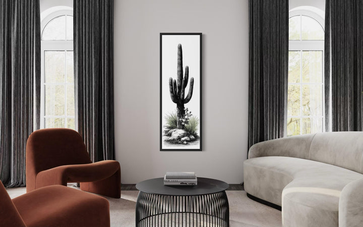 Tall narrow canvas wall art featuring a black and white saguaro cactus with subtle green accents.