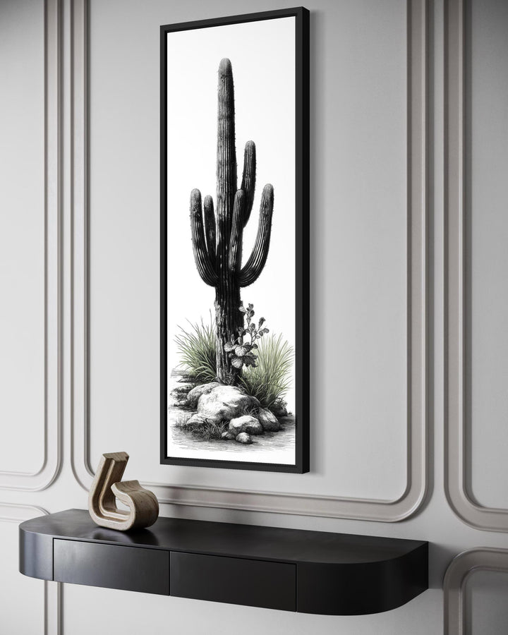 Tall narrow black and white saguaro cactus canvas wall art with subtle green accents in a black frame.