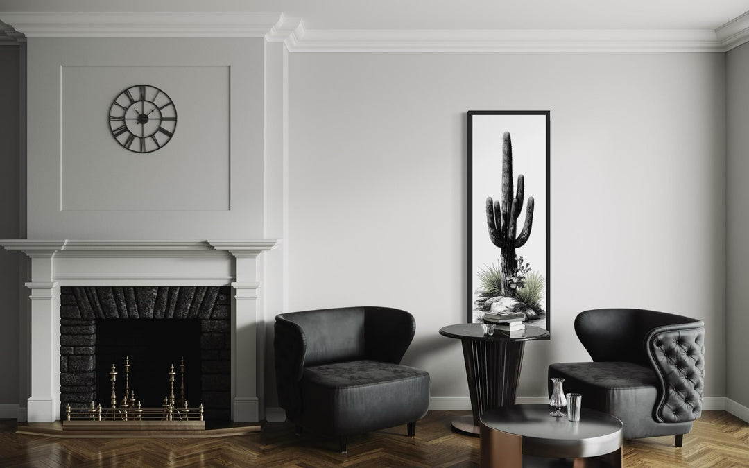 Tall narrow black and white saguaro cactus canvas wall art in a modern living room.
