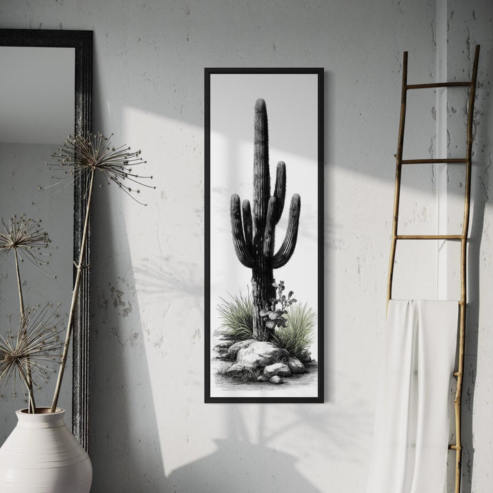 Tall narrow canvas wall art featuring a black and white saguaro cactus with subtle green accents.