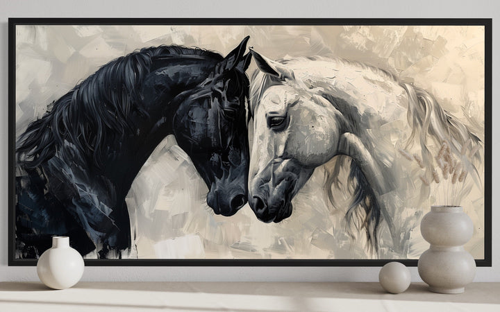 Framed canvas wall art of a black horse and a white horse touching heads in an abstract style.