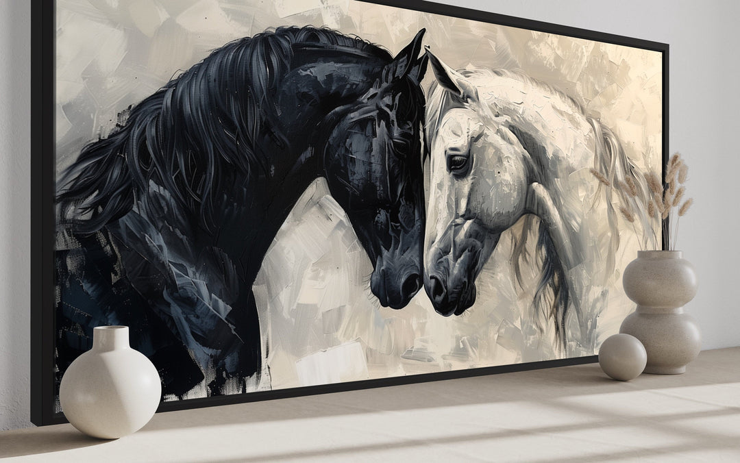 Framed canvas wall art of a black horse and a white horse touching foreheads in an abstract style.