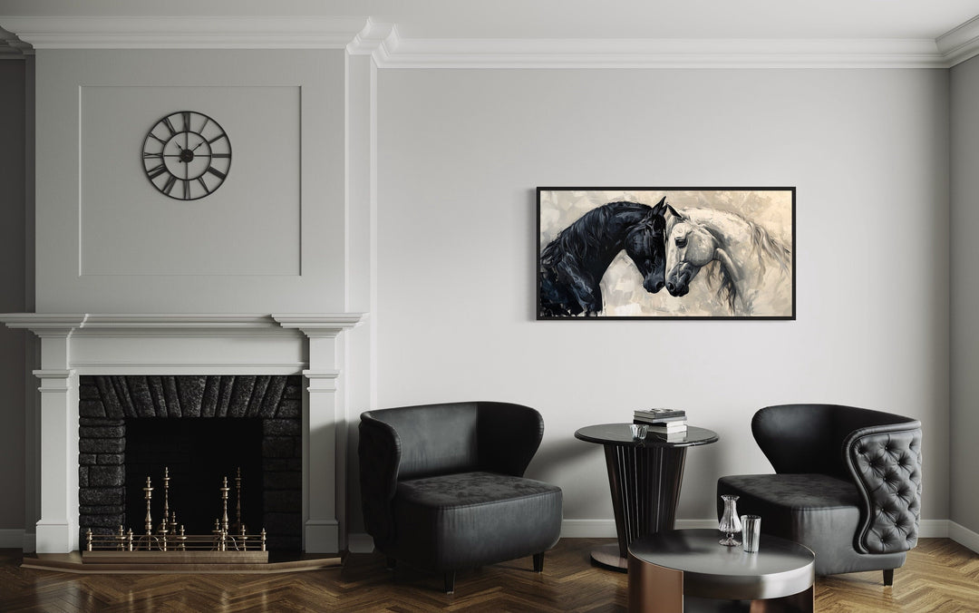 Framed canvas wall art of a black and white horse embracing, hung in a modern minimalist room.