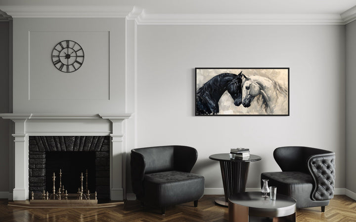 Framed canvas wall art of a black and white horse embracing, hung in a modern minimalist room.