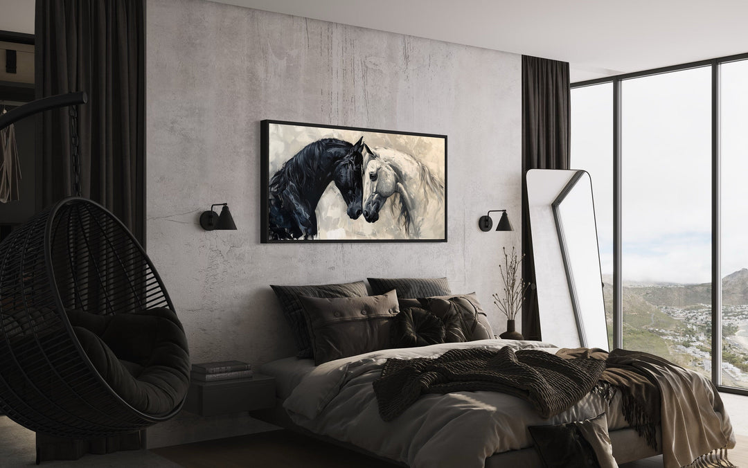 Framed canvas wall art of a black and white horse touching heads in a modern minimalist bedroom.