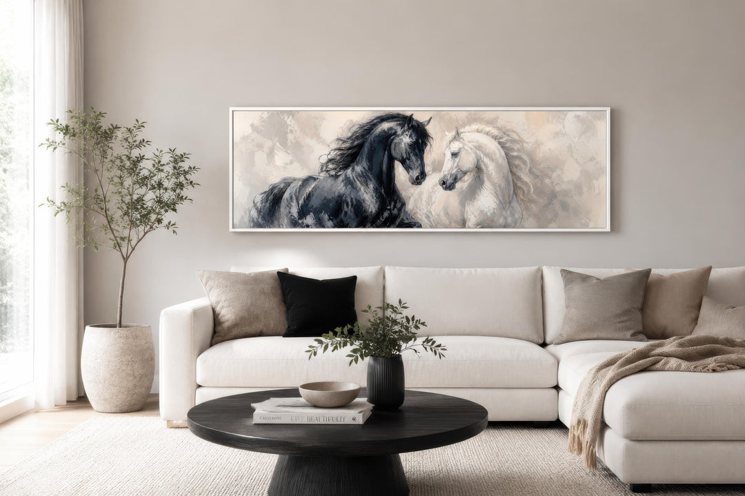 Long horizontal canvas print of a black and white horse in a romantic, painterly style above a sofa.