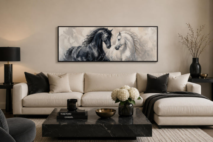 Long horizontal canvas print of a black and white horse in a romantic, painterly style above a sofa.