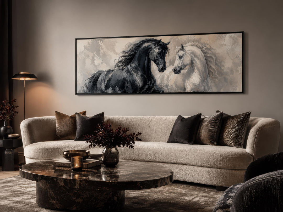 Long horizontal canvas print of a black and white horse in a modern living room above a sofa.