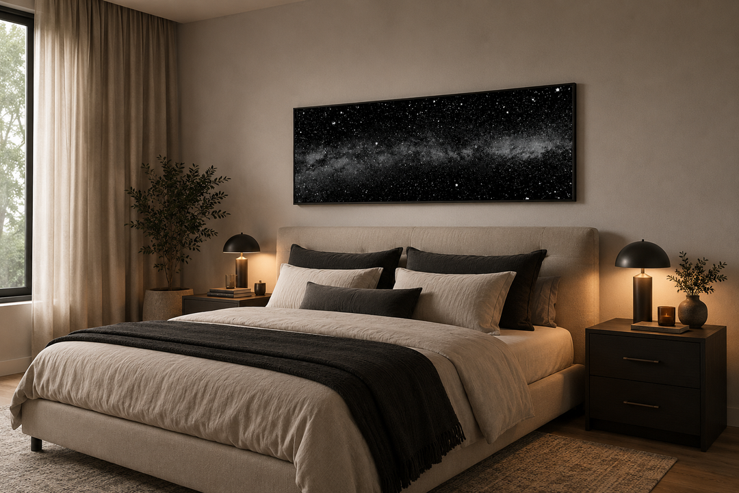 Framed black and white night sky canvas art above a bed in a modern bedroom.