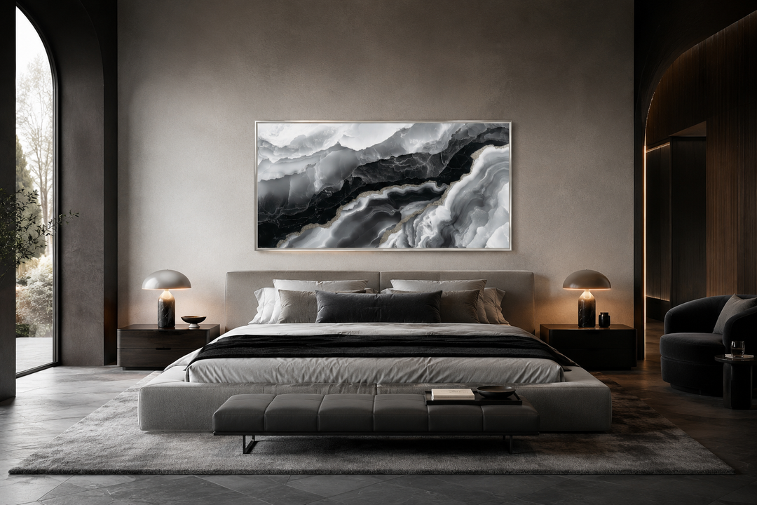 Horizontal black and white abstract marble canvas art hanging above a bed in a modern bedroom.
