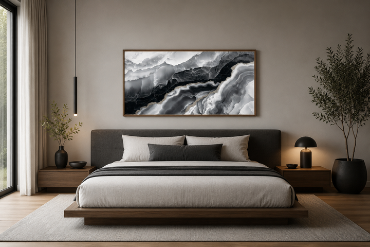 Horizontal abstract marble canvas wall art with black and white fluid patterns above a bed.
