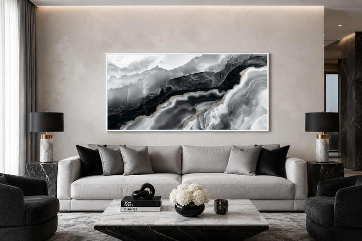 Abstract black and white marble canvas wall art above a modern grey sofa in a living room.