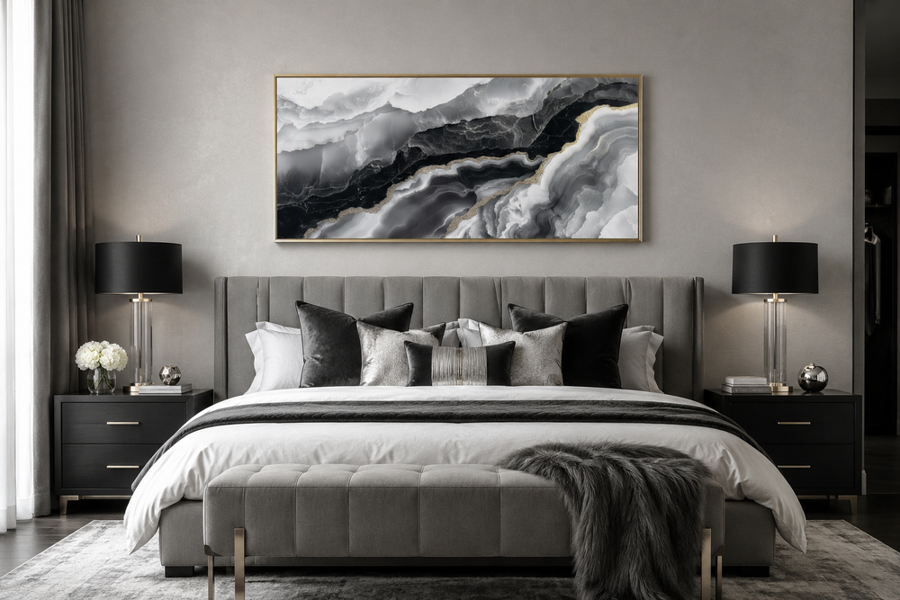 Horizontal abstract marble canvas wall art with black, white, and gold veins above a grey bed.