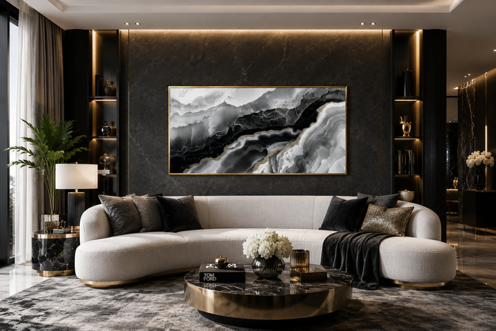Abstract black and white marble canvas wall art with gold accents above a modern white sofa.