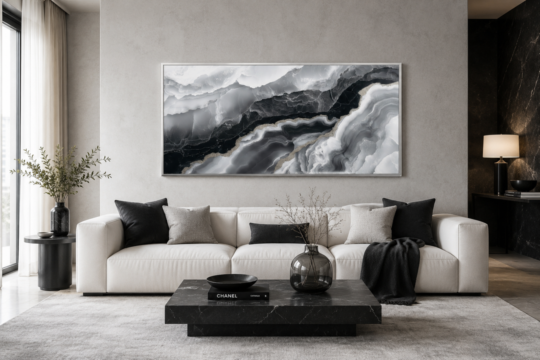 Abstract black and white marble canvas wall art displayed above a white sofa in a modern room.