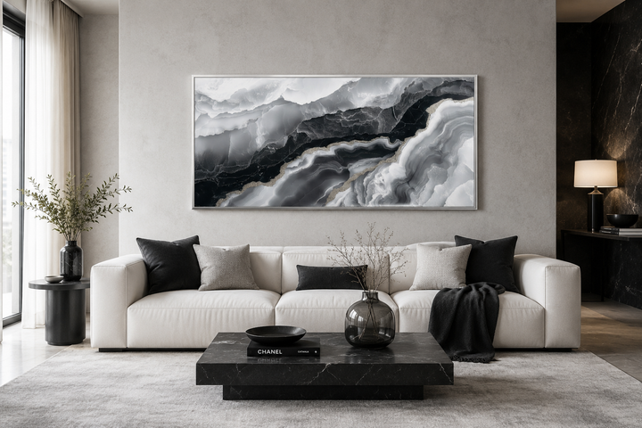 Abstract black and white marble canvas wall art displayed above a white sofa in a modern room.