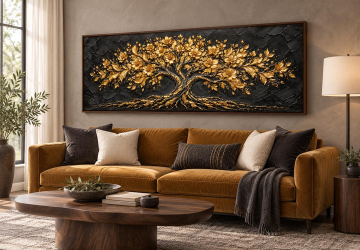 Black and Gold Flowering Tree long horizontal canvas wall art above a brown sofa in a living room.