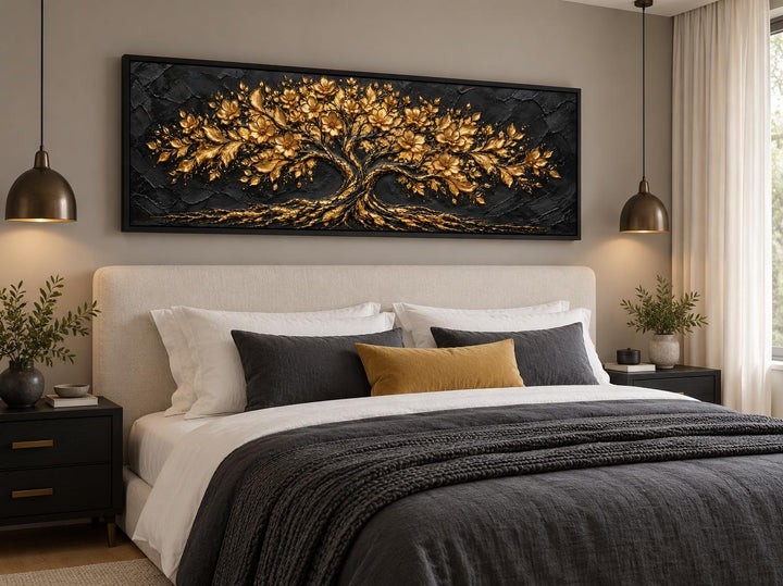 Black and gold flowering tree long horizontal canvas wall art hanging above a bed in a bedroom.