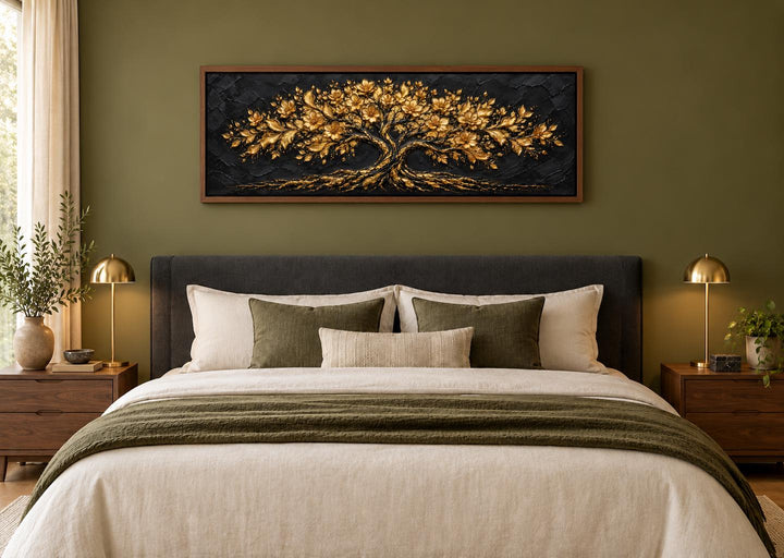 Black and gold flowering tree horizontal canvas wall art centered above a bed in a green room.