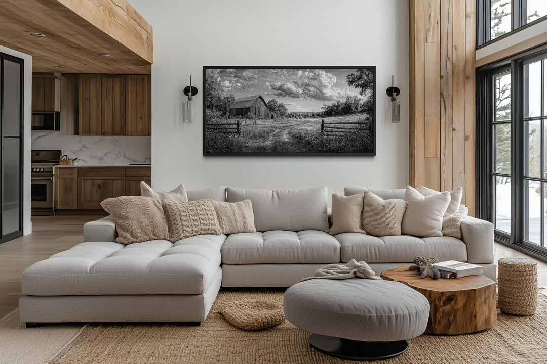 Black and white barn landscape canvas wall art in a rustic farmhouse living room.
