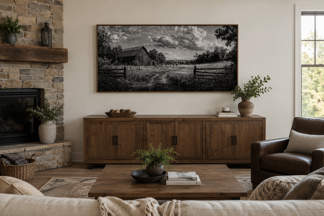 Black and white barn landscape canvas wall art in a rustic farmhouse living room above a sideboard.