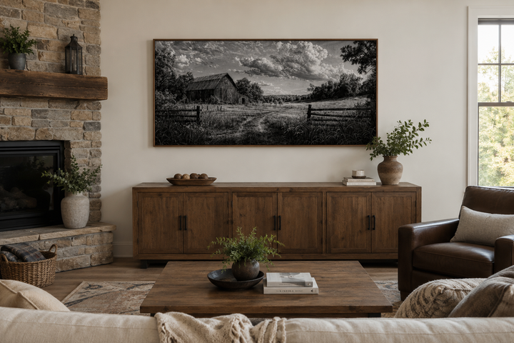 Black and white barn landscape canvas wall art in a rustic farmhouse living room above a sideboard.