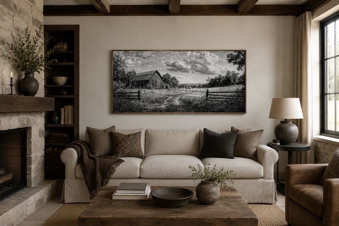 Black and white barn landscape canvas wall art above a sofa in a rustic farmhouse living room.